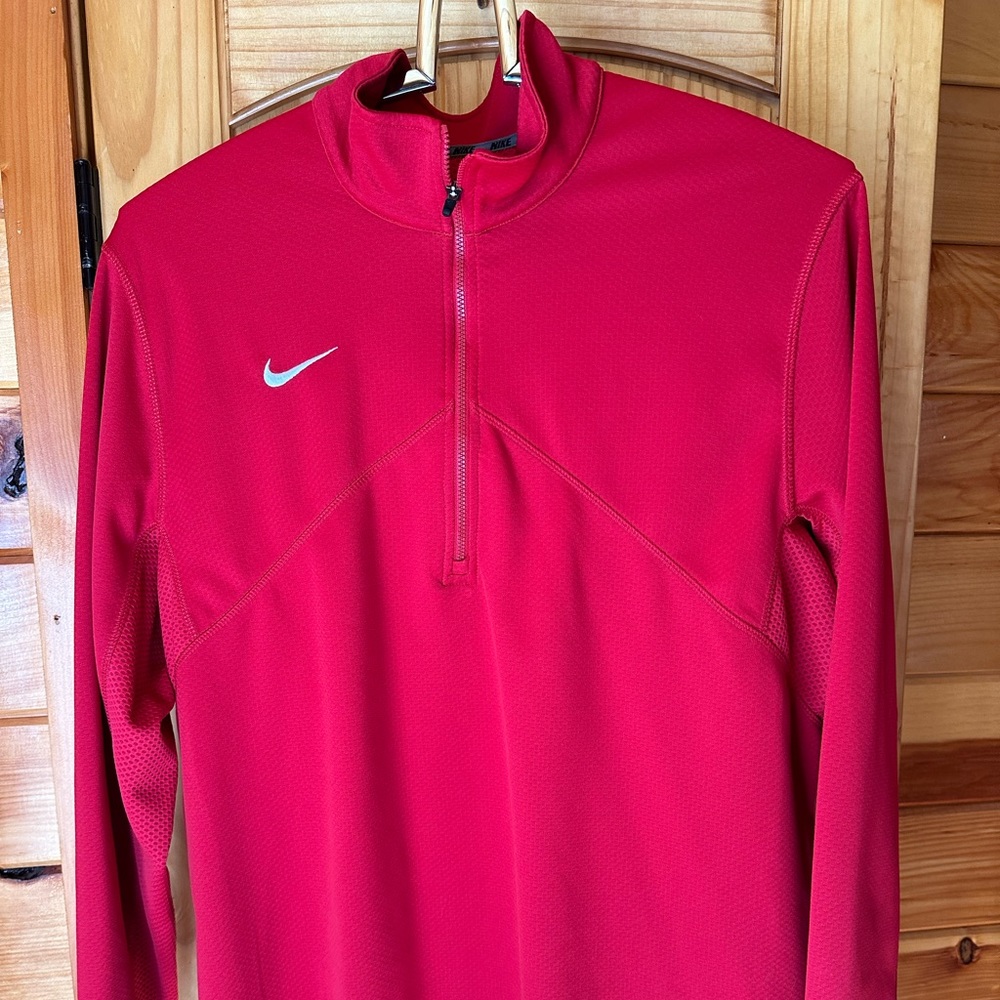 This is a Nike dry fit athletic top with zipper pocket